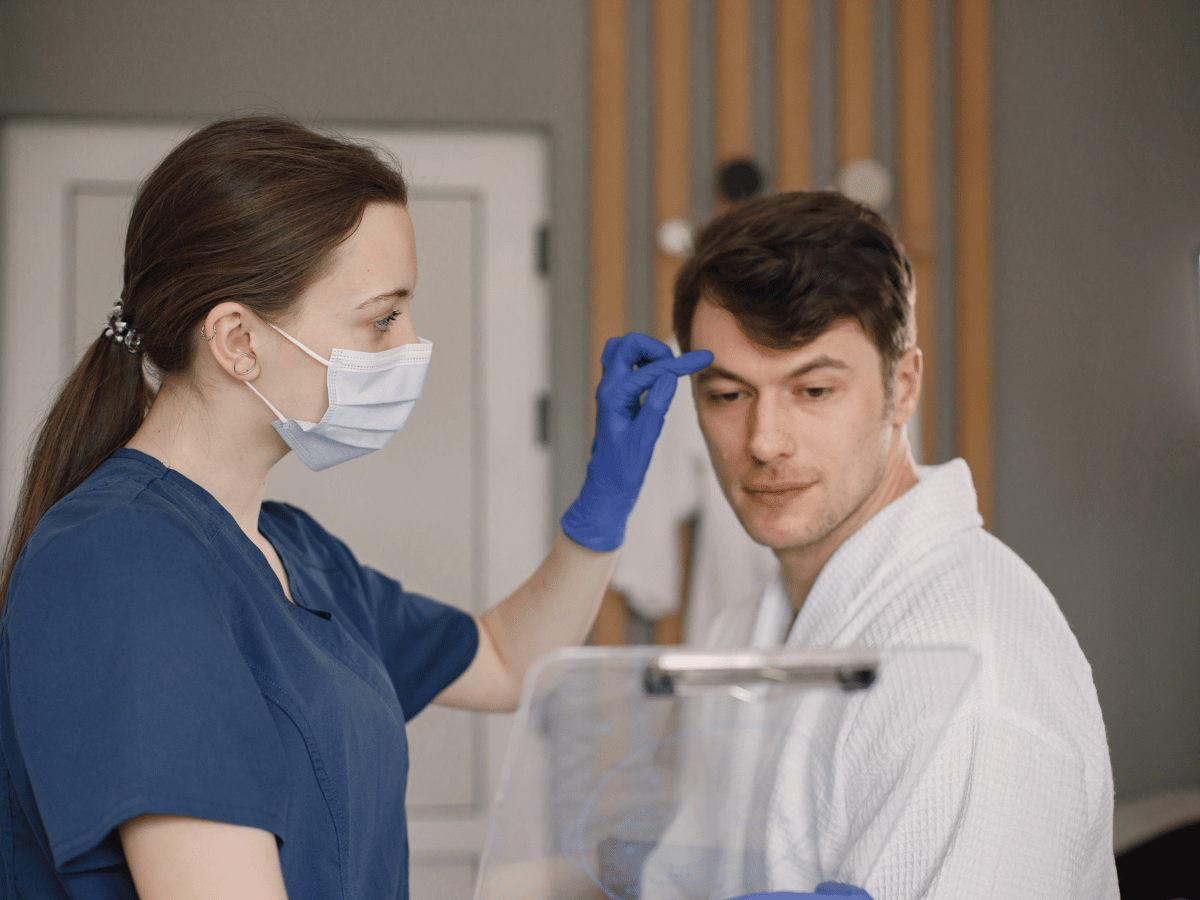 doctor examining patient's skin and scalp